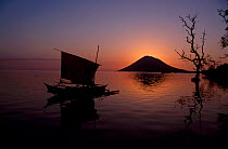 Fishing boat at sunset with Manado Tua volcano in background Bunaken Indonesia
