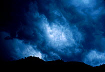 Turbulent dark rain clouds Bwindi forest NP Uganda